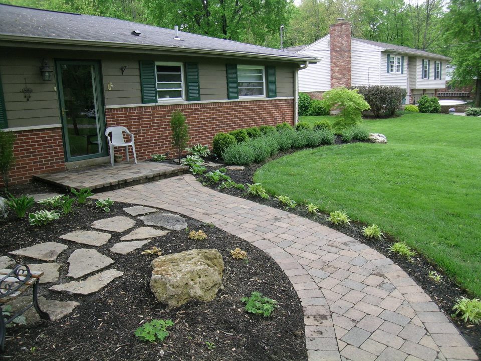 curved paver path to front door lined with landscape